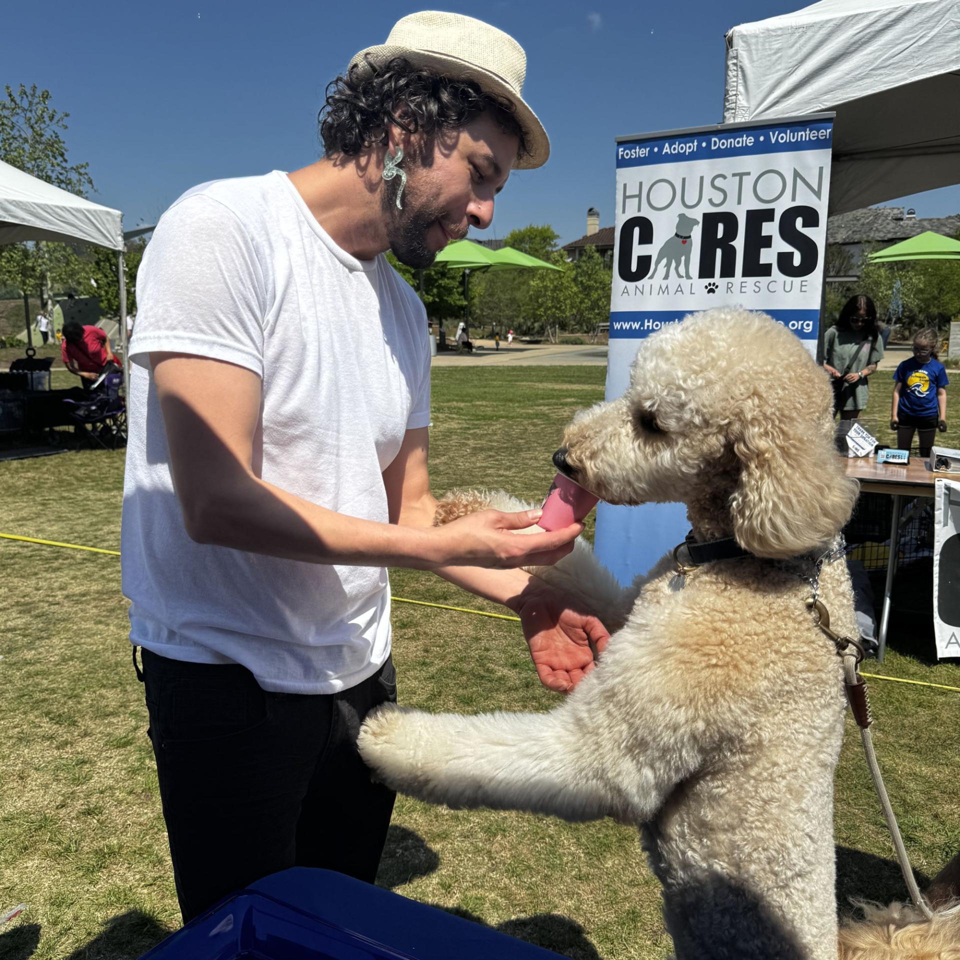 Bark in the Park RVAH Booth 4 Olympo feeding a dog a pup cup